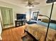 Bedroom featuring hardwood floors, a TV, and natural light from a window at 4219 Berkshire Dr, Sarasota, FL 34241