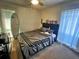 Cozy bedroom with a large bed, neutral tones, and a surfboard adding a touch of personality at 4219 Berkshire Dr, Sarasota, FL 34241