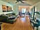 Open concept living room and dining area with hardwood floors and tropical themed artwork at 4219 Berkshire Dr, Sarasota, FL 34241