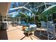 Screened-in patio with comfortable seating and dining area, perfect for outdoor relaxation and entertaining at 4219 Berkshire Dr, Sarasota, FL 34241
