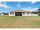 Expansive backyard featuring a screened-in lanai, lush green lawn, and well-maintained landscaping at 4262 70Th Street E Cir, Palmetto, FL 34221