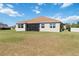 Spacious backyard featuring lush lawn, beige exterior, and screened-in lanai, perfect for outdoor relaxation at 4262 70Th Street E Cir, Palmetto, FL 34221
