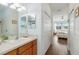 Bathroom with a view to bedroom, white cabinets, laminate countertop, and a stand-up shower at 4262 70Th Street E Cir, Palmetto, FL 34221