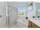 Bright bathroom featuring a large bathtub, glass shower, and a window with natural light at 4262 70Th Street E Cir, Palmetto, FL 34221