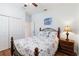 Bedroom featuring a comfortable bed with beach-themed decorations and a spacious closet at 4262 70Th Street E Cir, Palmetto, FL 34221