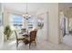 Dining area features a glass table, seating for four, and large windows with serene views at 4262 70Th Street E Cir, Palmetto, FL 34221