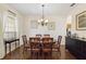 Formal dining room featuring an oval table with six chairs and decorative chandelier at 4262 70Th Street E Cir, Palmetto, FL 34221