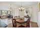 Cozy dining room boasts wood floors, chandelier, and table that seats six near living area at 4262 70Th Street E Cir, Palmetto, FL 34221
