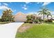 Charming home with a well-maintained lawn, mature trees, and a spacious driveway leading to an attached two car garage at 4262 70Th Street E Cir, Palmetto, FL 34221