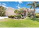 Charming home features a lush lawn, mature trees, and colorful landscaping enhancing its curb appeal at 4262 70Th Street E Cir, Palmetto, FL 34221