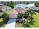 Beautiful single-story home features a well-manicured lawn, lush landscaping, and a scenic waterfront view with a fountain at 4262 70Th Street E Cir, Palmetto, FL 34221