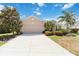 Inviting single-story home boasts a spacious driveway, well-kept lawn, and colorful landscaping with mature trees at 4262 70Th Street E Cir, Palmetto, FL 34221