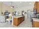 Kitchen area featuring an island with seating, modern appliances, and easy access to the living room at 4262 70Th Street E Cir, Palmetto, FL 34221