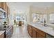 Bright kitchen boasts wood cabinets, tiled floors, and a view of the dining area and backyard at 4262 70Th Street E Cir, Palmetto, FL 34221