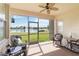 Enclosed patio with seating, lake views, and outdoor ceiling fan at 4262 70Th Street E Cir, Palmetto, FL 34221