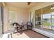 Relaxing screened lanai features comfortable seating, a ceiling fan, and sliding glass doors at 4262 70Th Street E Cir, Palmetto, FL 34221