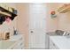 Functional laundry room with washer, dryer, storage shelves, and utility sink at 4262 70Th Street E Cir, Palmetto, FL 34221