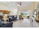 Bright living room with tile flooring, high ceilings, ceiling fan, and sliding doors to the lanai at 4262 70Th Street E Cir, Palmetto, FL 34221