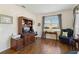 Comfortable living room features wood floors, built-in shelving, and natural light from the window at 4262 70Th Street E Cir, Palmetto, FL 34221