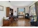 Cozy living room features wood flooring, stylish furniture, and a large window offering natural light at 4262 70Th Street E Cir, Palmetto, FL 34221