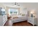 Inviting bedroom features a ceiling fan, a lake view, and rocking chair at 4262 70Th Street E Cir, Palmetto, FL 34221
