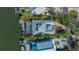Overhead view of the property with a screen enclosed pool, dock, and canal access at 5024 Commonwealth Dr, Sarasota, FL 34242