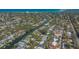 Stunning aerial view of a waterfront property with lush landscaping and canal access to the bay at 5024 Commonwealth Dr, Sarasota, FL 34242