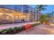 A landscaped backyard with a red bench and a pool at 5024 Commonwealth Dr, Sarasota, FL 34242