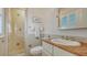 Bathroom with a glass-enclosed shower, decorative tiles, and a sink with marble countertop at 5024 Commonwealth Dr, Sarasota, FL 34242