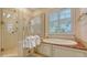 A bathroom with a bathtub and a walk-in shower at 5024 Commonwealth Dr, Sarasota, FL 34242