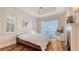 A bright bedroom with plantation shutters and a tray ceiling at 5024 Commonwealth Dr, Sarasota, FL 34242