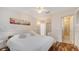 Bright bedroom features hardwood floors, a ceiling fan, and an attached bathroom with tiled shower at 5024 Commonwealth Dr, Sarasota, FL 34242