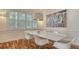 Bright dining area featuring hardwood floors, modern decor and large windows that bring in natural light at 5024 Commonwealth Dr, Sarasota, FL 34242