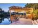 A waterfront dock with a pergola and seating at 5024 Commonwealth Dr, Sarasota, FL 34242