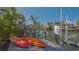 Dock featuring two kayaks and a boat lift, surrounded by lush greenery and tranquil waters at 5024 Commonwealth Dr, Sarasota, FL 34242
