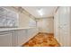 Well lit Laundry Room with storage cabinets, terra cotta tiled floors and multiple windows at 5024 Commonwealth Dr, Sarasota, FL 34242