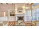 Bright living room features a fireplace, built-in cabinets, and ample natural light at 5024 Commonwealth Dr, Sarasota, FL 34242