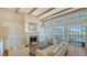 Bright living room features a fireplace, built-in cabinets, and ample natural light with water views at 5024 Commonwealth Dr, Sarasota, FL 34242