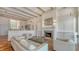 Spacious living room with beamed ceilings, fireplace and seamless transition to outdoor living at 5024 Commonwealth Dr, Sarasota, FL 34242