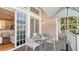 Covered outdoor patio with stylish dining set and serene outdoor views at 5024 Commonwealth Dr, Sarasota, FL 34242