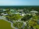 An aerial view showcasing community buildings, green spaces, and a pond in a park-like setting at 5115 Foxhall Rd, North Port, FL 34288