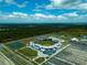 Aerial view of modern baseball stadium featuring multiple fields and a parking area at 5115 Foxhall Rd, North Port, FL 34288
