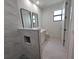Modern bathroom featuring stylish tile, a walk-in shower, and a well-lit vanity at 5115 Foxhall Rd, North Port, FL 34288