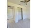 Bright bedroom with wood-look floors, closet with sliding doors, and ceiling fan at 5115 Foxhall Rd, North Port, FL 34288