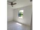 Bright bedroom featuring a ceiling fan and a window offering natural light at 5115 Foxhall Rd, North Port, FL 34288