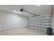 Garage interior with new door and grey floor at 5115 Foxhall Rd, North Port, FL 34288