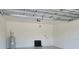Garage interior with water heater, door to interior, and dark floor mat at 5115 Foxhall Rd, North Port, FL 34288