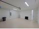 Spacious garage with epoxy floor, utility sink, and ample room for storage and two cars at 5115 Foxhall Rd, North Port, FL 34288
