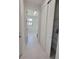 Hallway and sliding door closet with shelving at 5115 Foxhall Rd, North Port, FL 34288