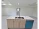 Modern kitchen island features a stainless steel sink and dishwasher, with sleek cabinets at 5115 Foxhall Rd, North Port, FL 34288